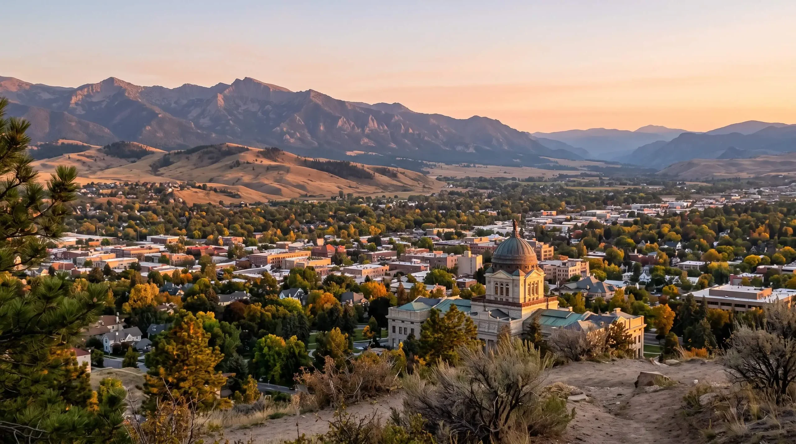 Helena, Montana with the state Capitol dome and the Rocky Mountains at golden hour