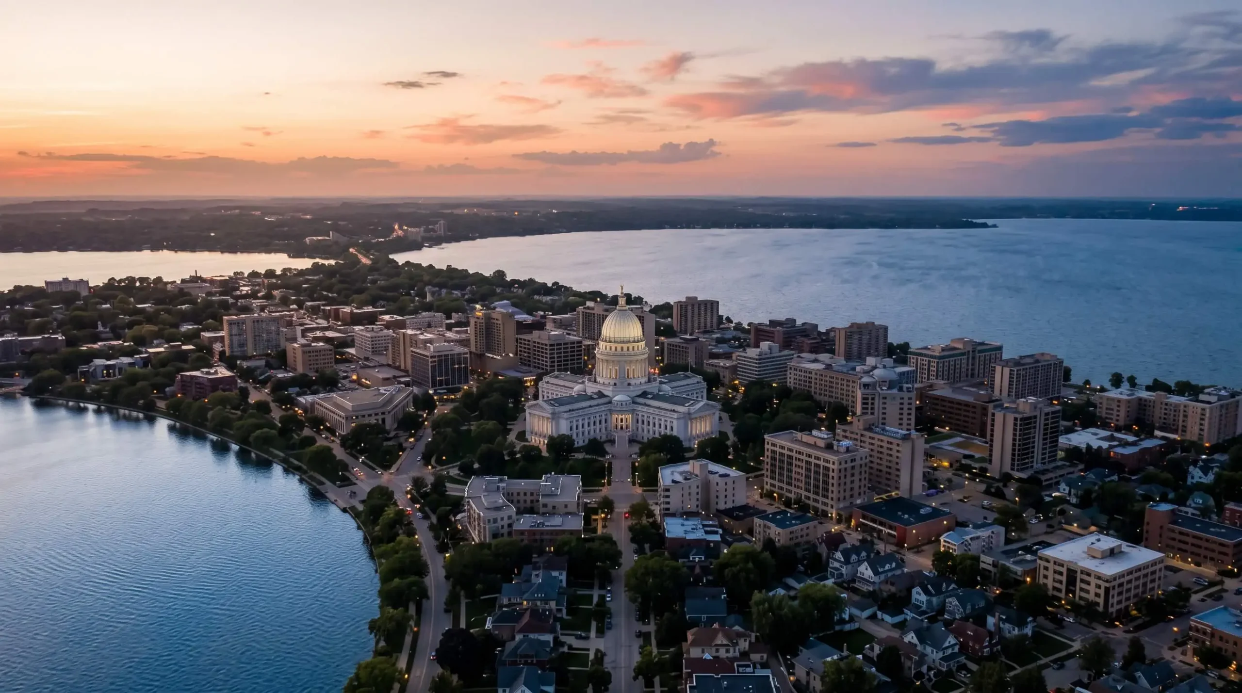Madison, Wisconsin on its isthmus between two lakes with the white granite Capitol dome at sunset